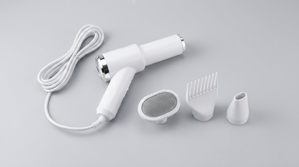 PawDry dryer laid out with its coiled cord and three attachments — slicker brush, wide comb and concentrator nozzle