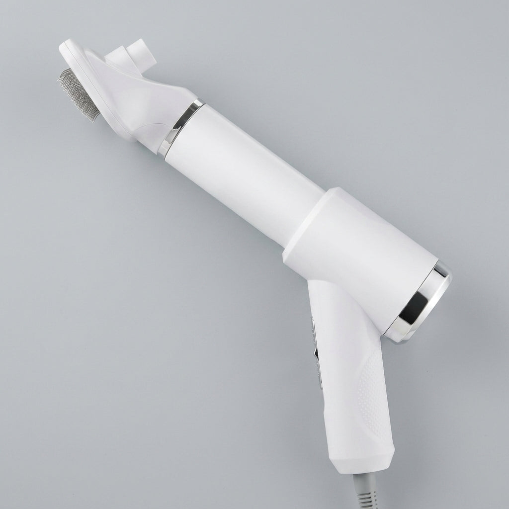 PawDry grooming dryer brush in white with the slicker brush attachment fitted, on a light background